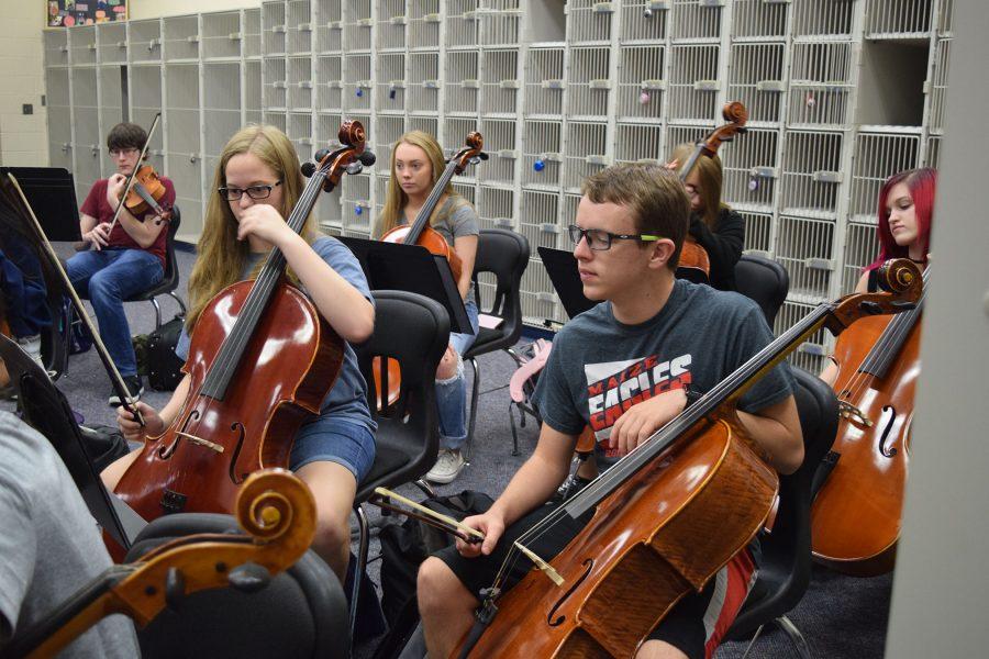 The students participating in orchestra practice for an upcoming performance.
