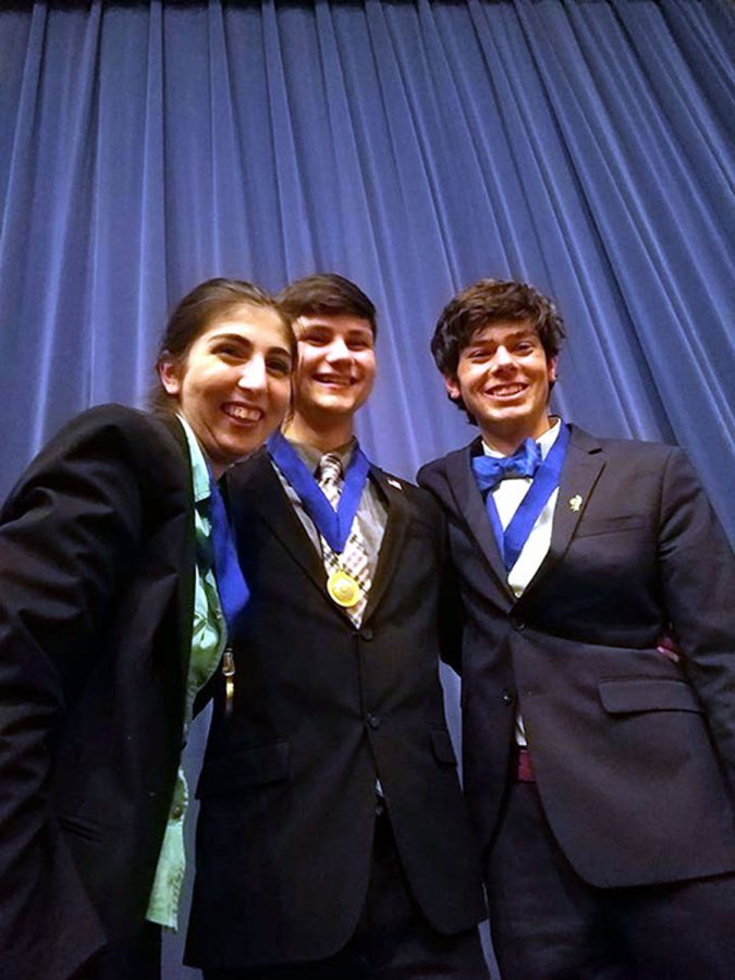 Forensics nationalist, Kimiya Monfared, Ethan Cox,  and Sam Harder posing for a picture. This event took place at Wichita East High School. Photo courtesy of W. Rice