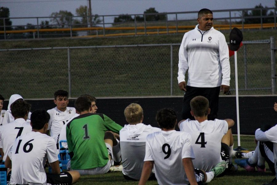 Coach Rey Ramirez talks to the boys during halftime at Goddard about their skill and performance. The Mavericks defeated the Lions 8-0.