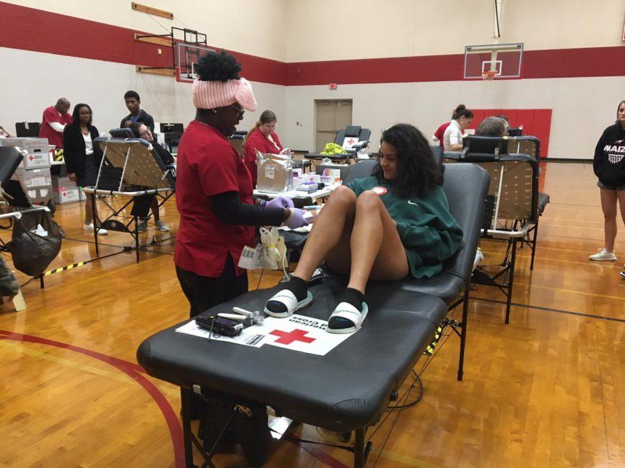 Students giving blood to the Red Cross for the blood drive. 