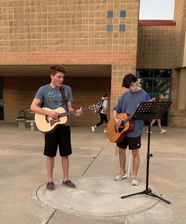 Senior, Mitch Adamson, and Junior, Tate Johnson, playing worship music outside of school. Adamson and Johnson have played outside of the school building in the morning. 