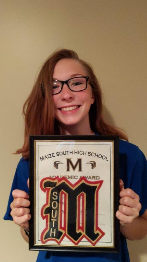 With a smile Zoe Hansen, senior, proudly holds her academic letter. I am super excited to get a head start on my life, said Hansen. 