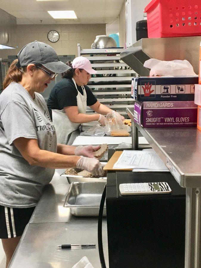 Maize South cafeteria ladies prepare chicken nuggets for school lunch early Friday, September 6.