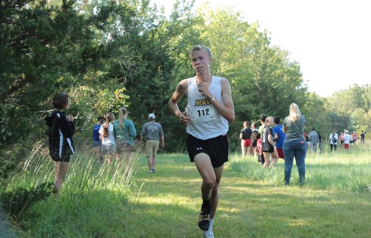 Senior Trey Rios gallops past several competitors at the Bishop Carroll Meet at Lake Afton near Cheney. Trey came in 3rd place, with a time of 17:11.