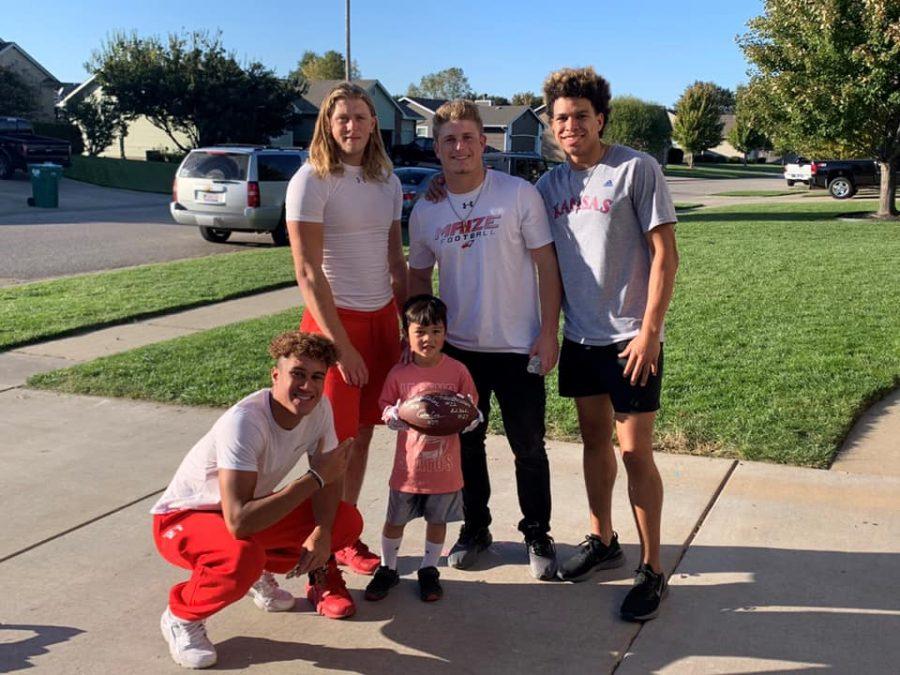 Seniors Caden Cox, Keaton Robertson, Andrew Hanlin and Preven Christon pose with Lucas Vo. The players attended his birthday and gave him a signed football