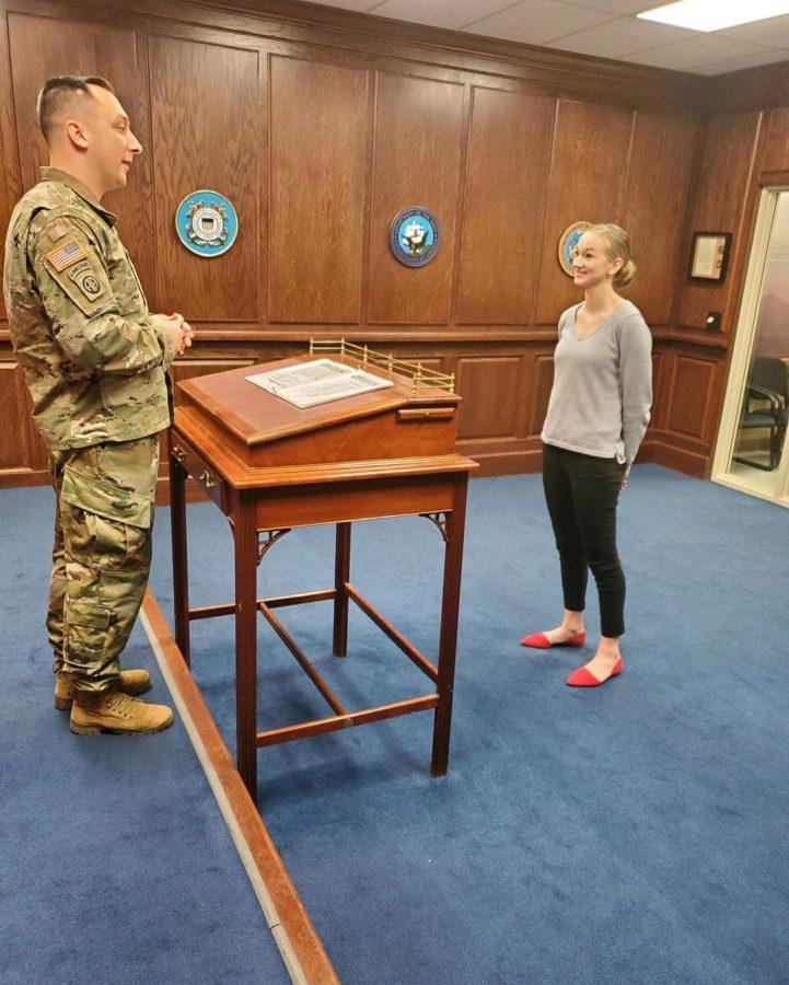 Senior Madelyn Mies swearing into the United States of America Navy at MEPS in Kansas City. Mies was inspired by all of her friends and family surrounding her to pursue joining the Navy. 