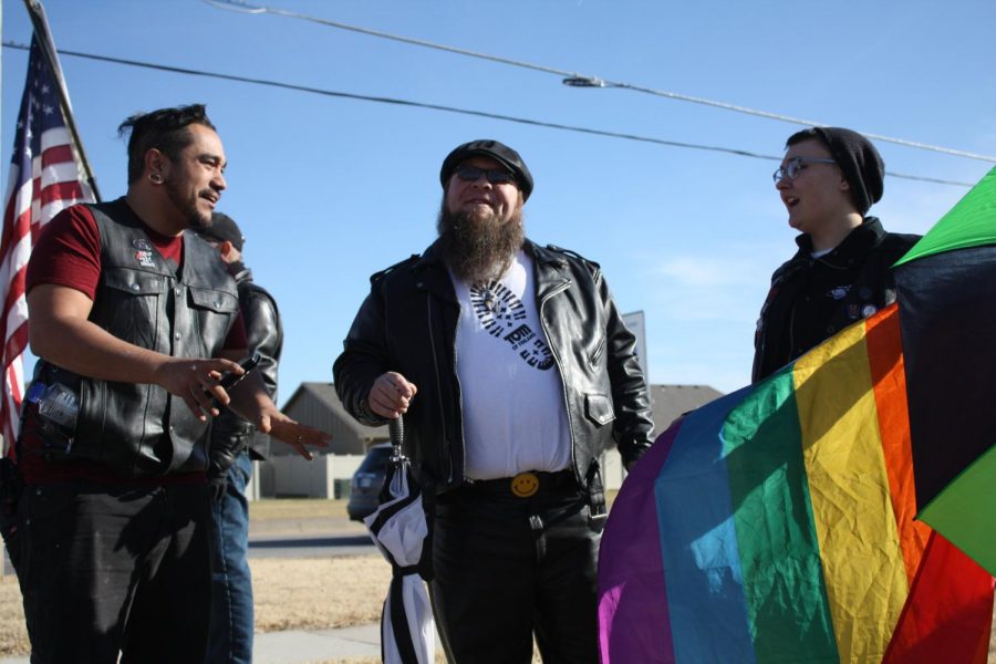 On December 11, a group of pro LGBTQ+ counter-protesters converse with one another, ignoring the Westboro Baptist Church protesters in front of Maize South High School.