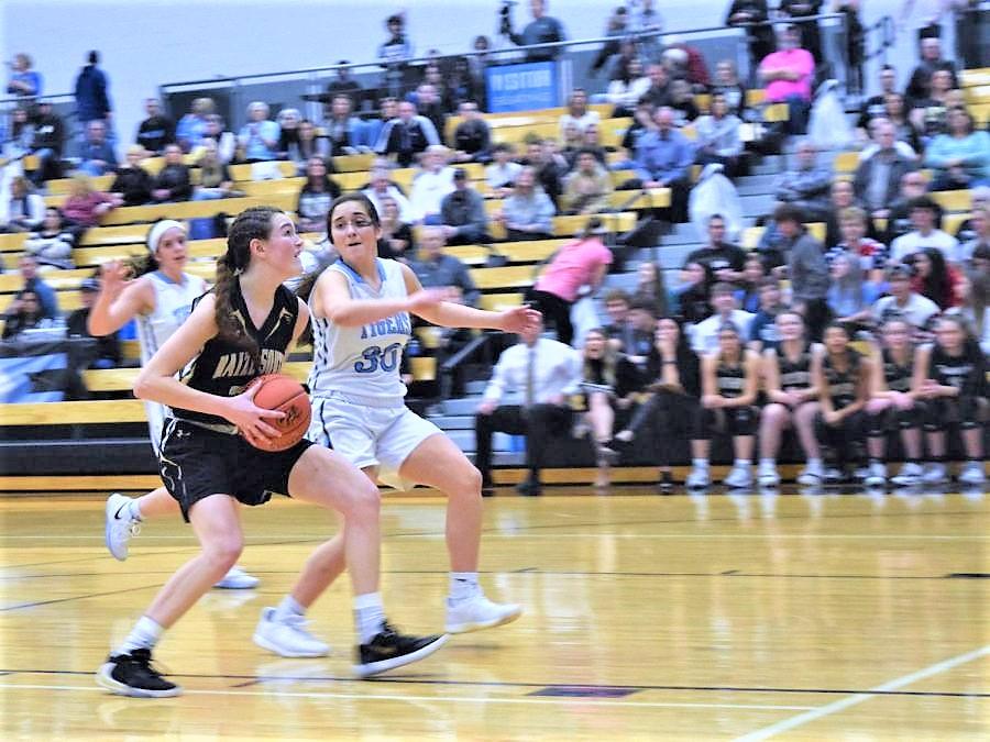 Preparing to deliver a shot in the paint, forward Macy McCormack evades a defender on a breakaway for a two-point shot.