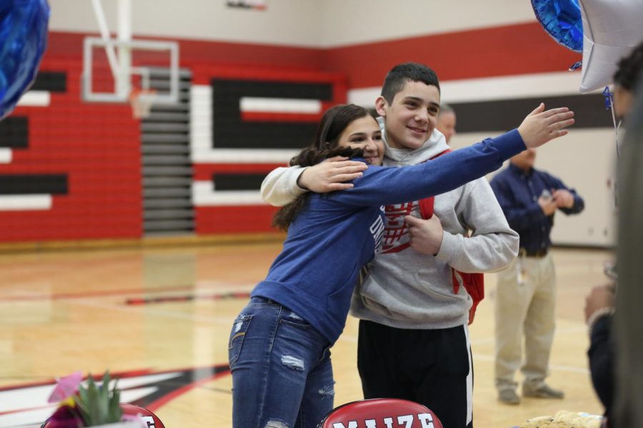 Senior Emily Laham and Freshman Dominic Espinoza celebrate before Lahams signing on Wednesday.