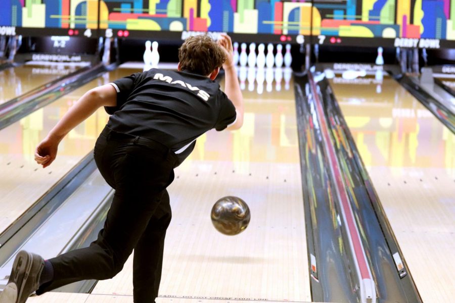 Throwing the ball down the lane, sophomore Carter Bowles aims for a strike at the Varsity Triangular on Monday, February 3.
