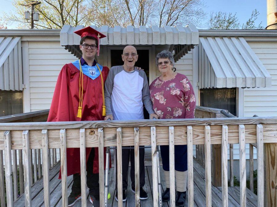 Senior Casey Loving visited his grandparents in New Jersey earlier this month. He was happy that he got to take a photo in his graduation gown with his grandfather who died Monday.