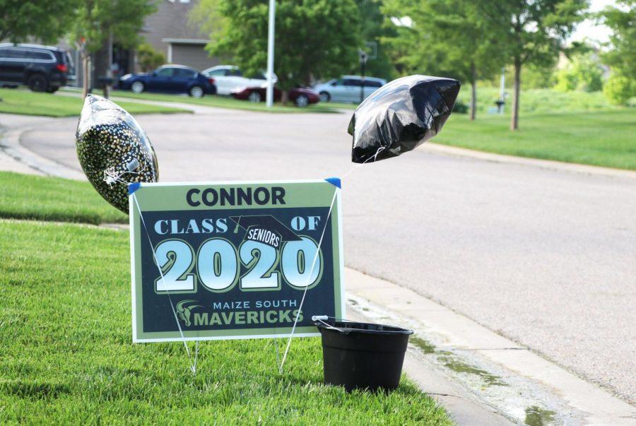 Balloons, streamers, graduation caps and signs printed with local vendors lined 2020 senior yards during the drive-through celebration.