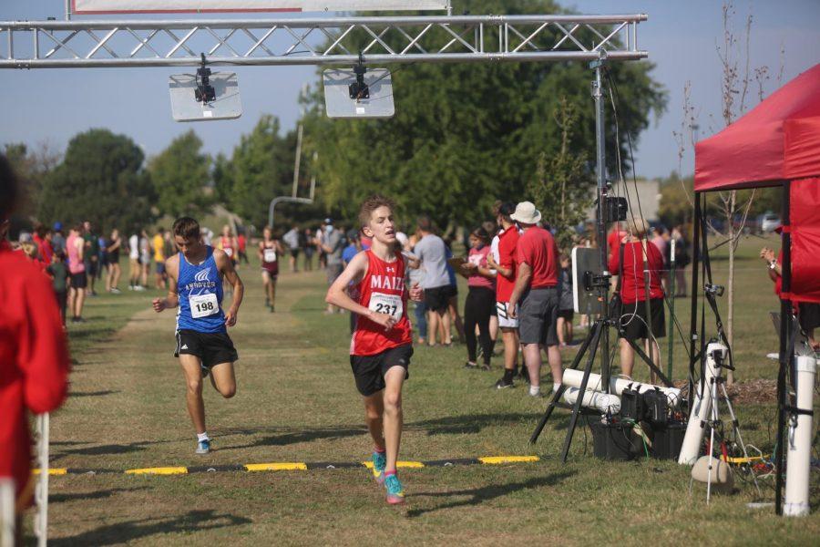 Sophomore Zachary Johnson crosses the finish line placing seventh with a time of 17:36.