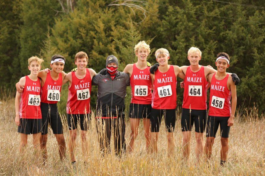 The boys cross country varsity team takes a photo after their win at Regionals. The team will now prepare for the state meet Oct 31.