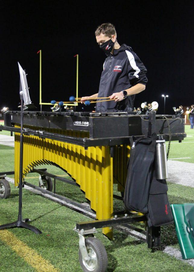 Sophomore Evan Rogerson, plays the xylophone during the first halftime performance of the season for the marching band.