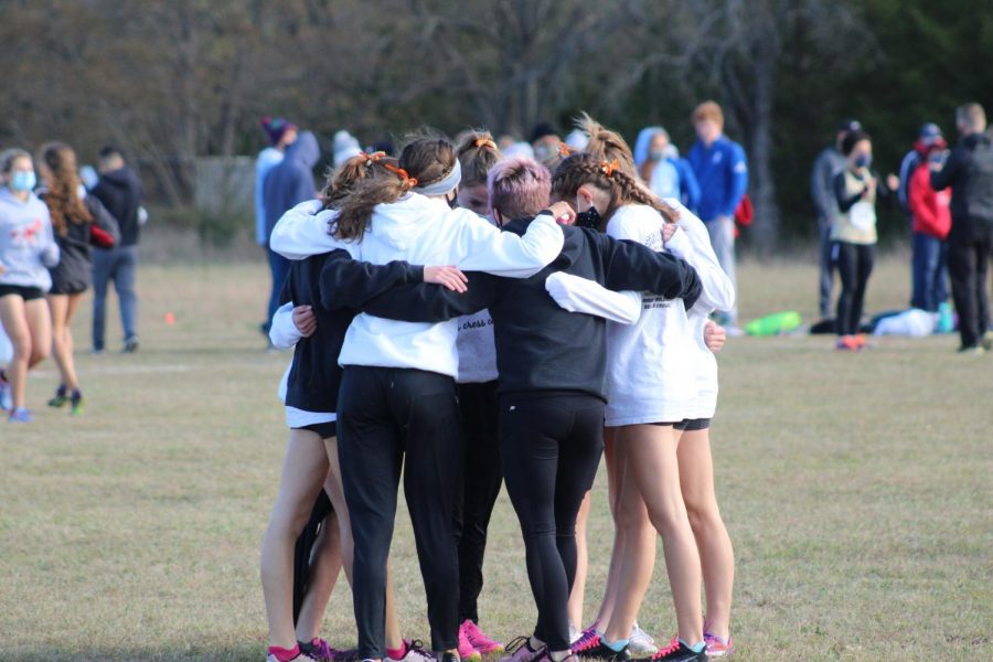 The girls on the Maize South cross country team come in for a hug before their 4 mile race for the State Championship last Saturday.  The girls won the state championship, three of the runners placing in the top twenty overall on the day.