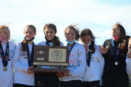 The girls on the Maize South cross country team proudly hold their well-deserved trophy from the state championship.  This is the first year they have won the KSHAA State Championship since 2016 for their third state championship in eleven years at Maize South.