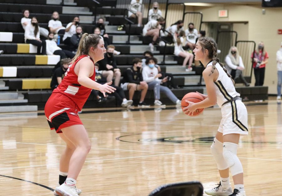 Alexis Davis, 11, dribbles the ball closer to the net to try for a basket against Maize High defender Sydney Holmes. In the game, Davis scored three points for the night.