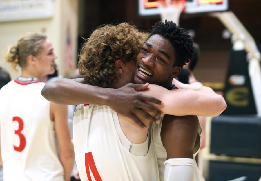 Senior Jacob Hanna hugs sophomore Justin Stephens after winning the first state basketball championship in Maizes history.