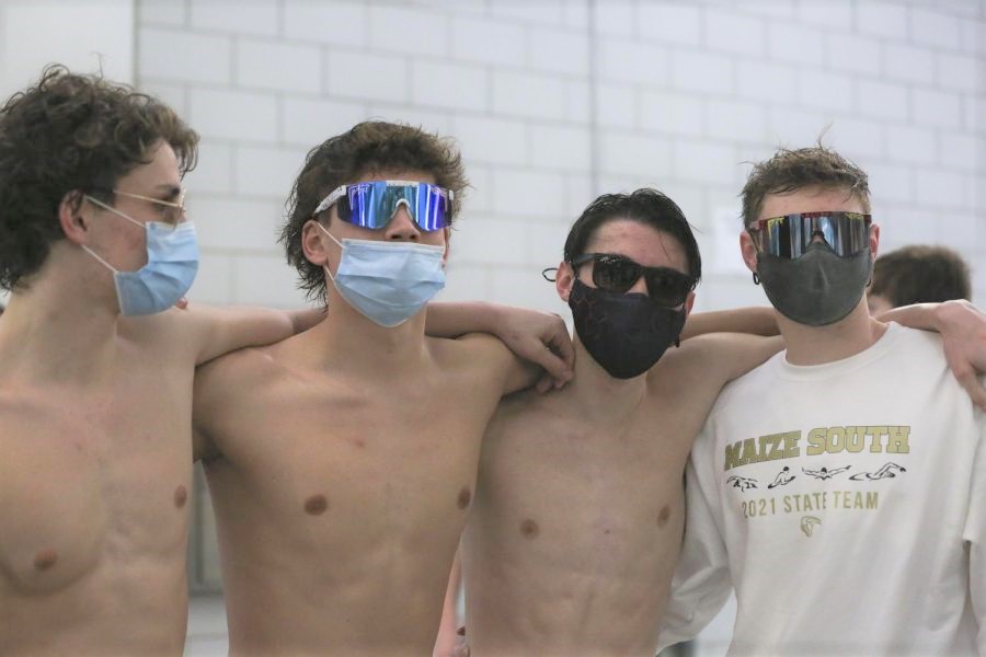 At the state 1A-5A swim meet, Reid and Regan Richardson celebrate with their teammates, Eli Stucky (12) and Brandon Bowles (12), after beating the state record in the 200 Freestyle Relay. The team finished third overall at the meet.