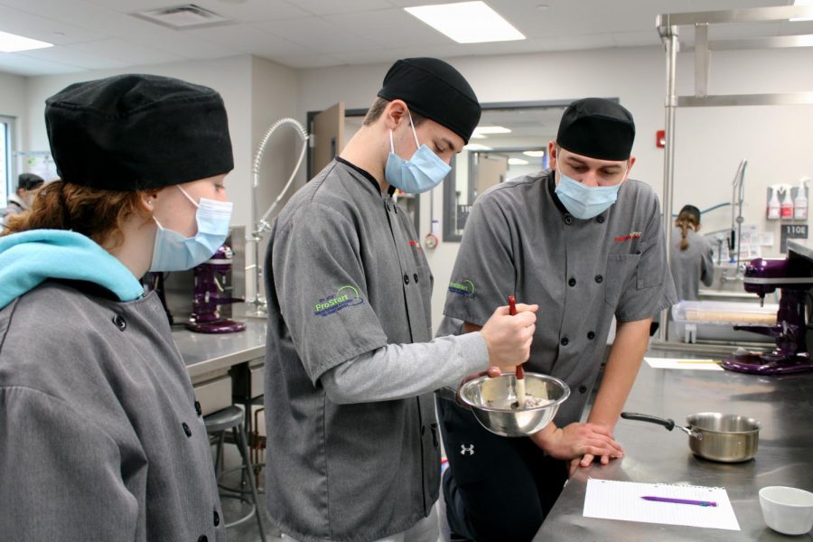 In Mariah Cammons Culinary group, the team starts to stir the chocolate in a bowl and all paying attention if they need to heat up the mixture more. If all the chocolate is at a perfect liquid, they can move on to the next step.