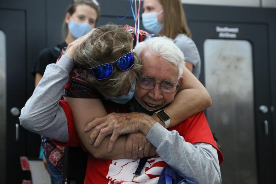 After being away from home for the trip, a veteran embraces a family member.