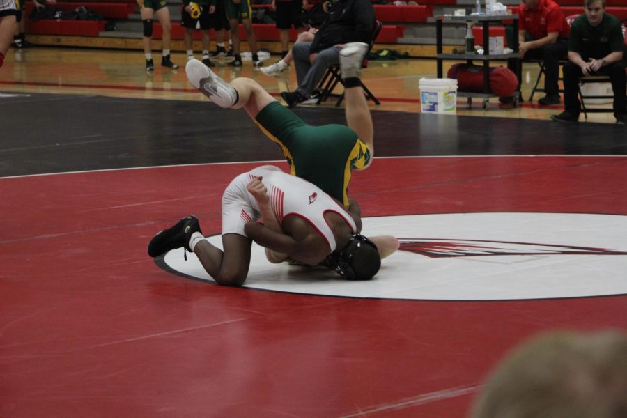 5A 2021 state champion Nakaylen Shabazz tackles his opponent to the ground.