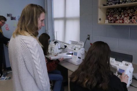 Students using an embroidery machine