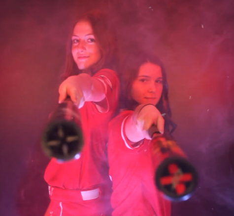 Junior Payton Samek and Kennedy Topping raise their bats for the Maize High softball hype video on Friday, March 11.