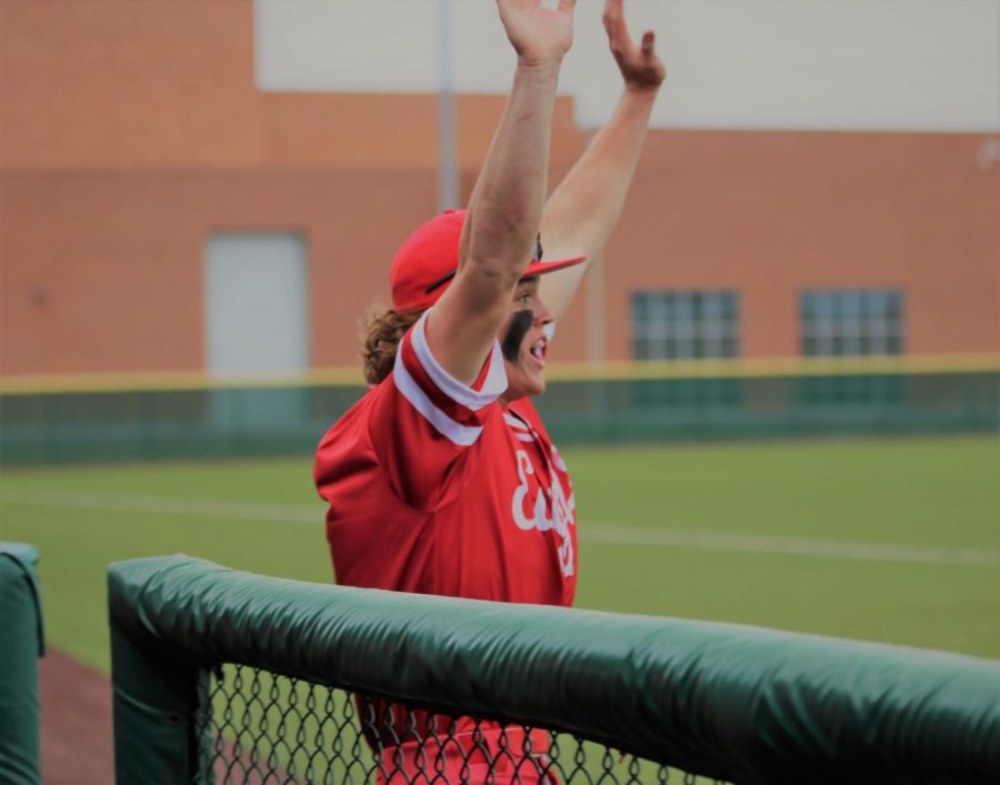 3rd baseman Justin Stephens throws his arms up in excitement after teammate Landon Helm hits a single and scores  2 points.