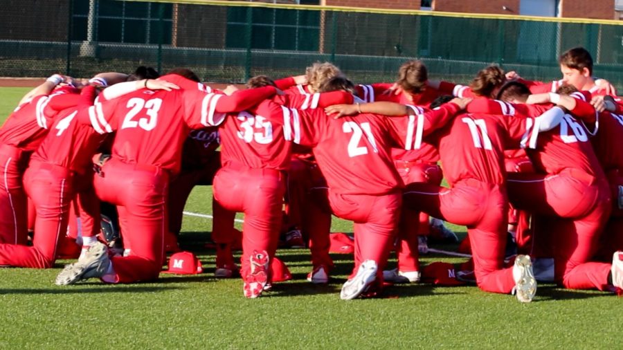 Maize High baseball players join together in prayer before their first game of the season against Bishop Carroll at home on Friday, March 25. The Eagles beat the Golden Eagles that evening 5-1 and are 6-1 so far this season.
