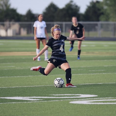 Sophomore Lexi Bauer runs to kick the ball in hopes to advance another goal. 