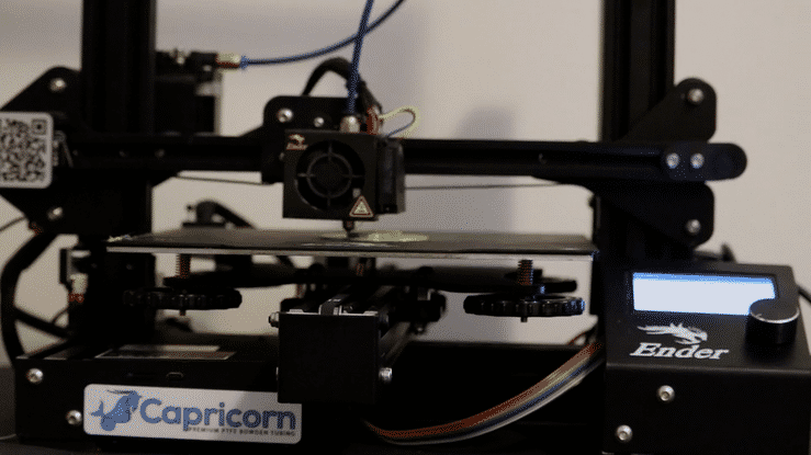 The 3D printer moves quickly to create multiple layers one a time to produce a skull figure. 