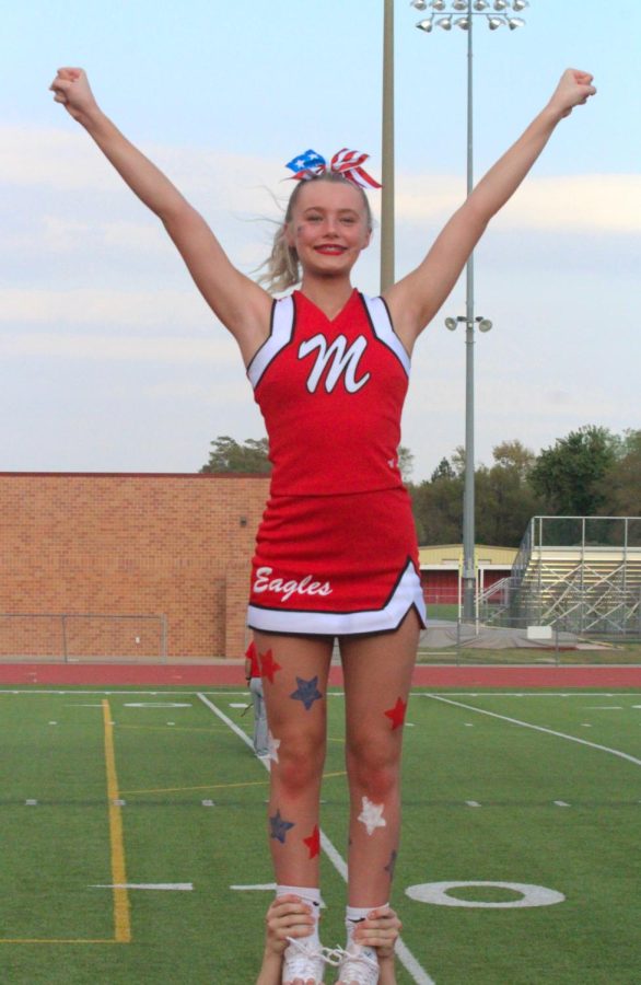 Sophmore Gentry Nittler, and the Maize High cheer team prepares their stunts moments before the Eagles take the field. The Eagles defeat the Railers 49-0 on Friday. 