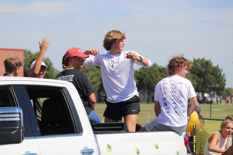 Throwing candy from the girls tennis float, sophomore, tosses candy to the students of Maize South. “I loved throwing candy out, and supporting the girls tennis team,” said Grizzell. 