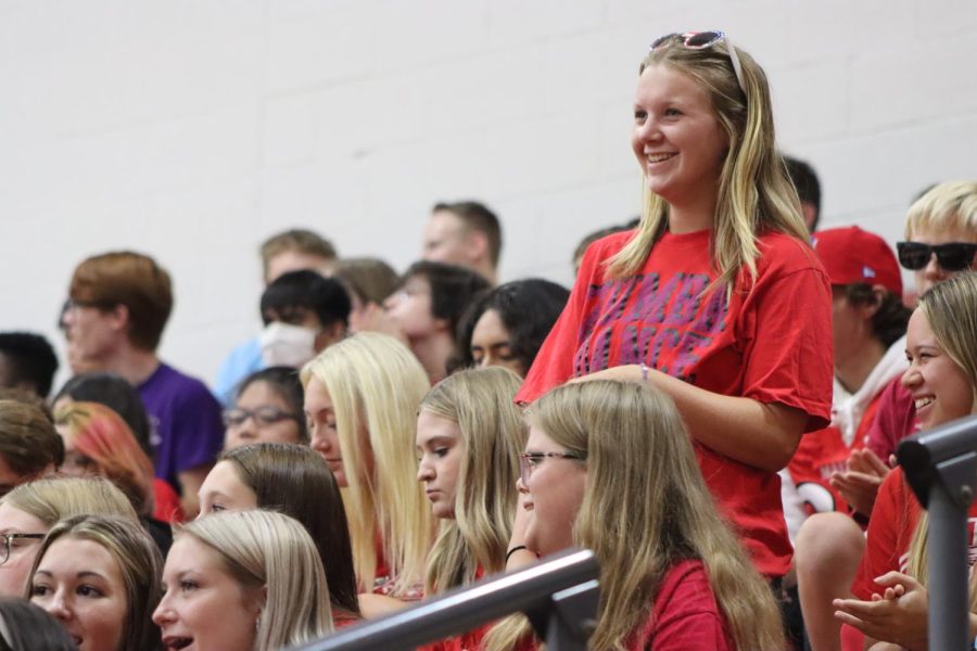 Junior Allie Palmer stands up to be recognized as a member of the Maize High girls tennis team at the pregame pep assembly. The Eagles defeated the Railers 49-0 on Friday. 