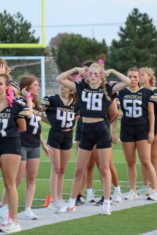 Senior Brittyn Herbig flexes at the junior powderpuff team moments before the first play of the game. Maize South juniors defeated Maize South seniors 18-12 in the annual homecoming powder puff game. 
