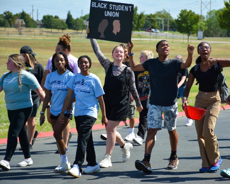 Maize South’s Black Student Union marches through the homecoming parade. The BSU was formed in 2020, and they have created a mural within the high school.