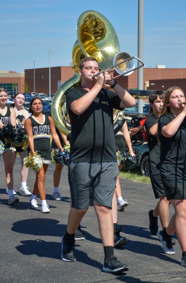 Senior Gavin Powers walks in the Maize South homecoming parade. Powers has been playing trombone with the Maverick marching band for all four years of his high school career. 