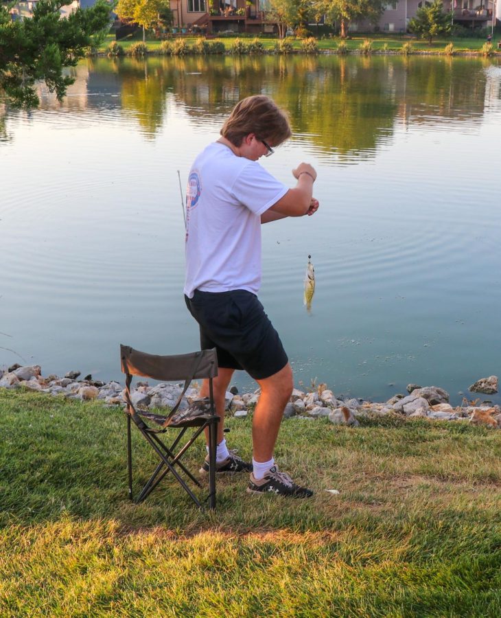 Senior Evan Perez brings in his fish he caught it in Outdoor Education