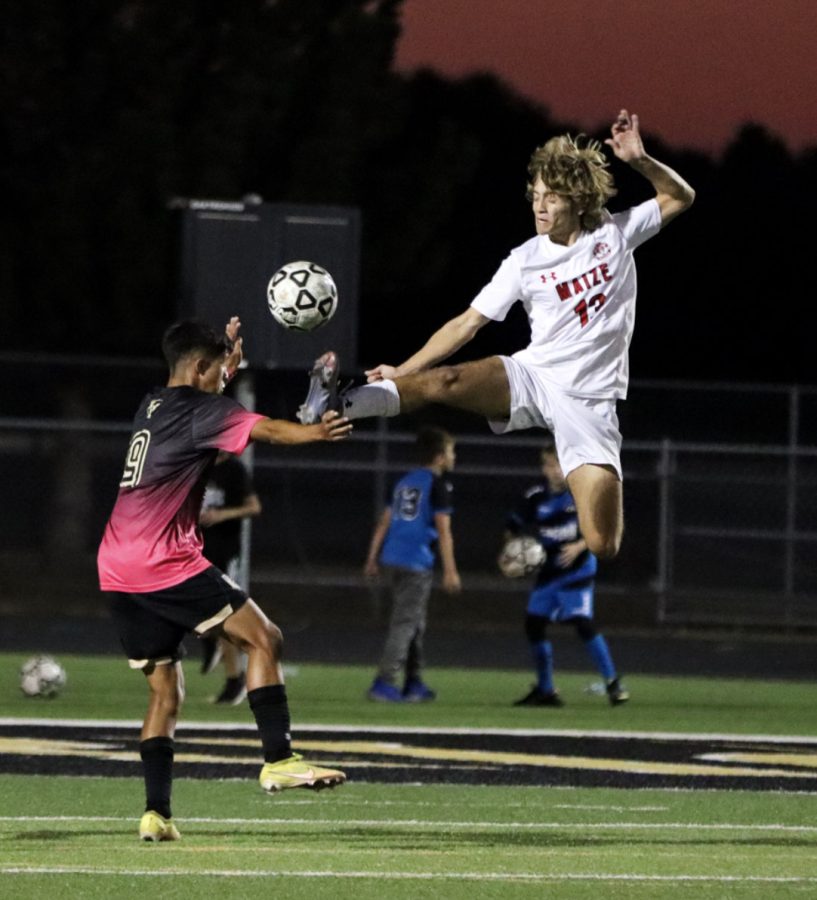 Maize Senior Zack Pappan jumps to get the ball away from the goalie box and keep the Mavericks from scoring. Maize South defeats Maize 4-0. 
