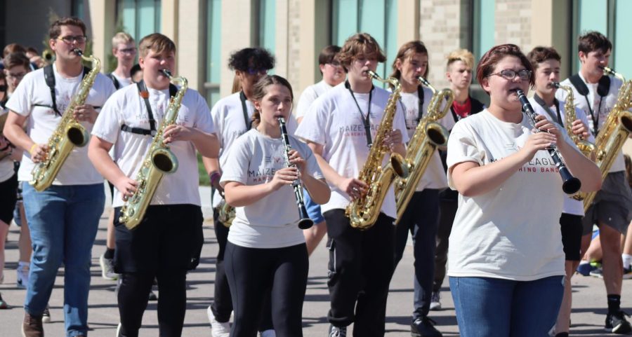 Marching along the front driveway of Maize Intermediate, the Maize High band starts off the parade with their fight song. Maize High School celebrated homecoming week with a parade for the first time in three years. 