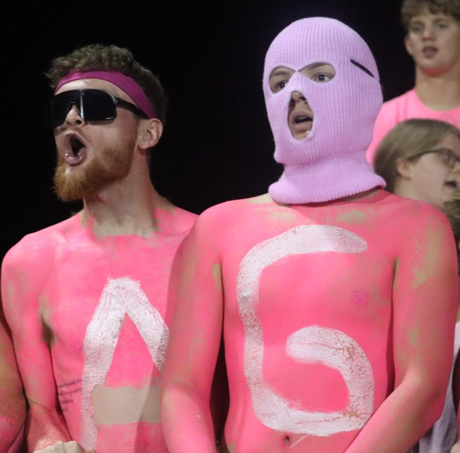 Two student section members cheer on the Maize Eagles football team. Maize High defeated Maize South by 63-26. 
