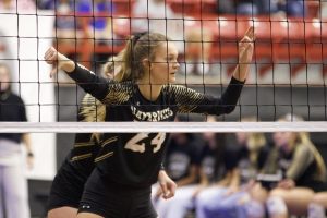 Maize South senior Avery Lowe signals to the back row that the setter is in the back row and there are three hitters. Seaman High School defeated Maize South in the first game of the state tournament 2-1. 