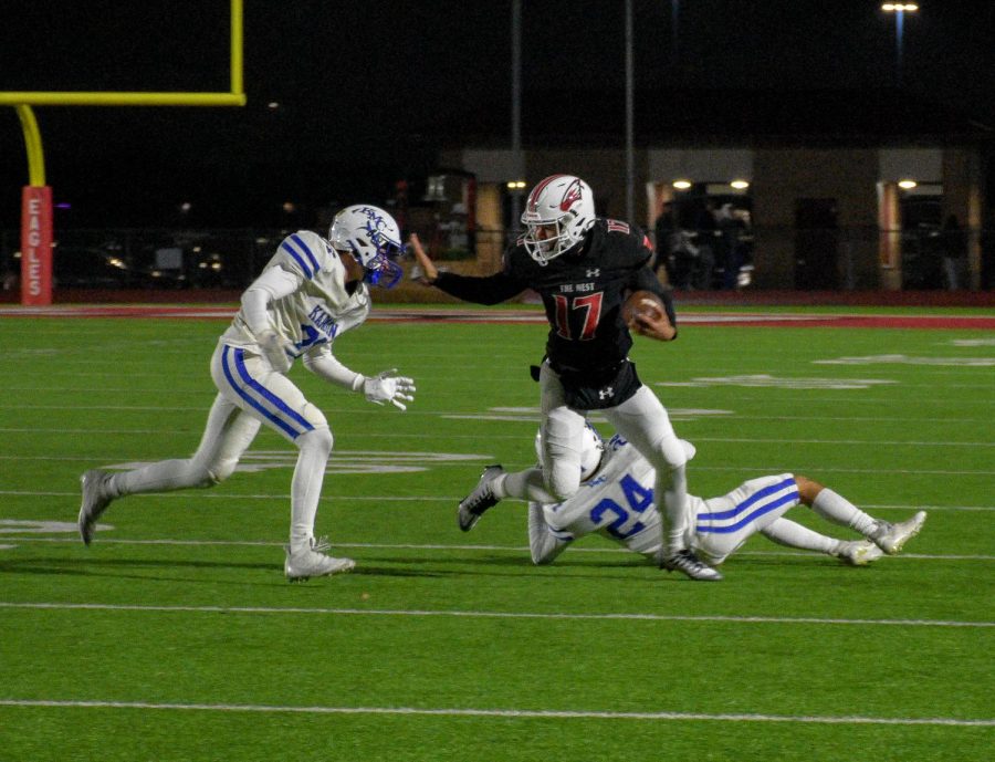 Maize junior receiver Jaeden Martin stiff arming a Kapaun defender after breaking loose from a tackle. Maize defeated Kapaun 43-14 and became the Regional Champions on Friday night.
