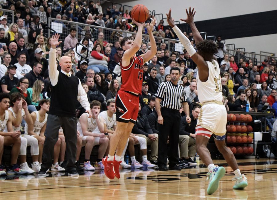 Maize senior Jaxon Booth goes up for a 3-point shot in the first half of the game. Maize fell to Maize South, 70-38. bringing the Eagles to a 2-2 record on the year.