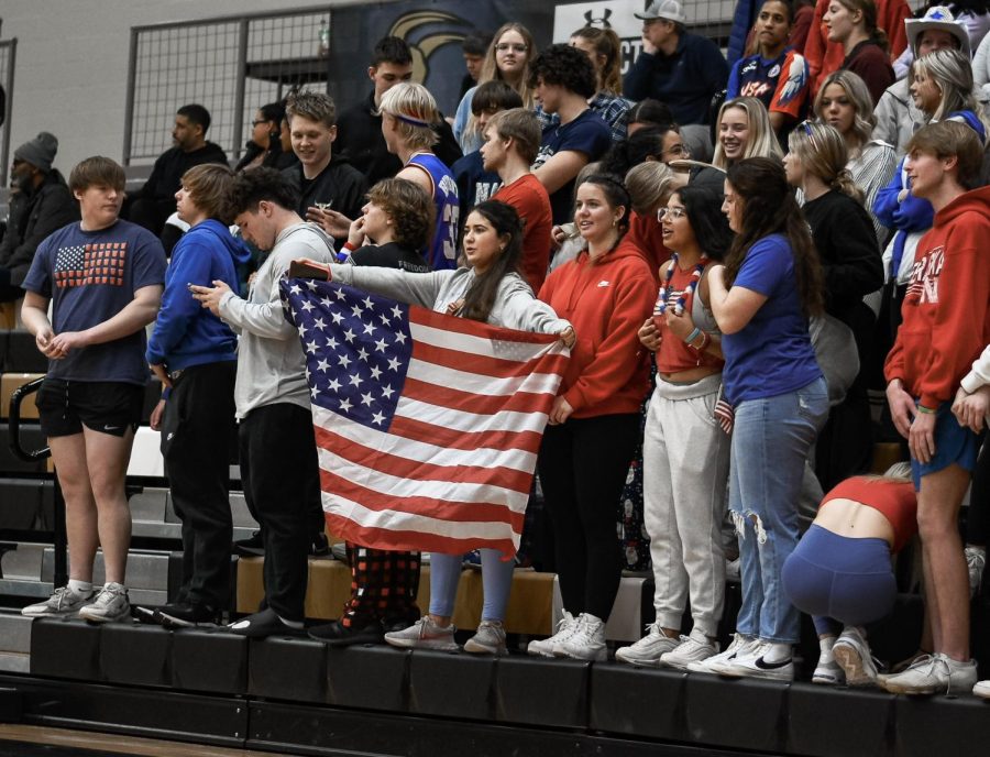 Senior Ana Garcia-Agulló waves the US flag in the student section. “The student section was really good and fun as always, and I love supporting the Mavs!” said Garcia-Agulló. Maize South’s student section theme was USA. The Mavericks defeated the Goddard Lions 63-30 Tuesday night.