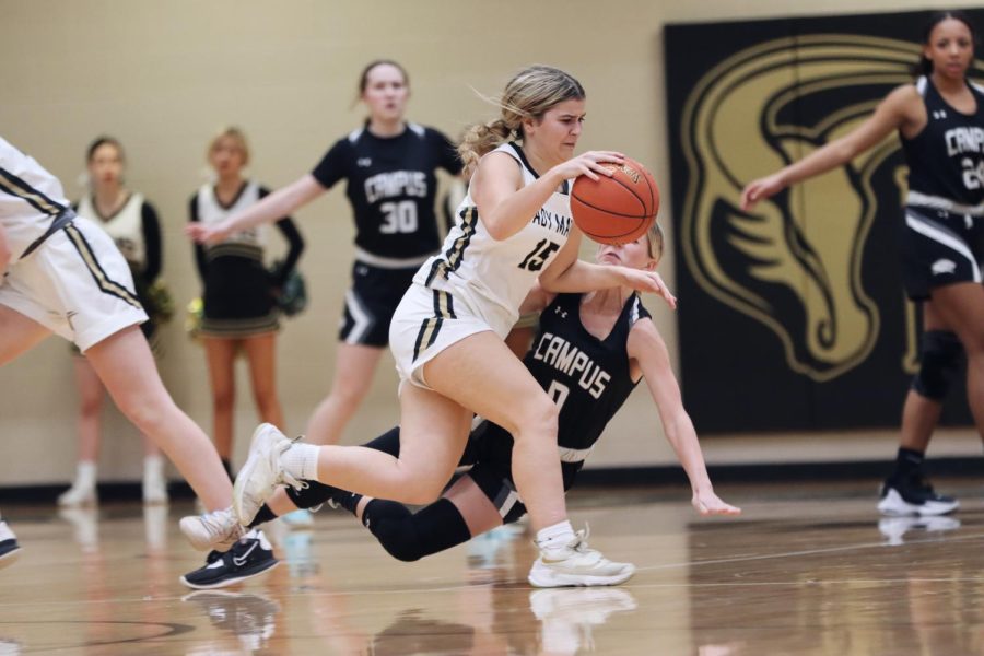 While on offense, Junior Bella Peters runs toward the goal, but trips up defender junior Daisy Cardinale. Maize South won against Campus 68-19. 