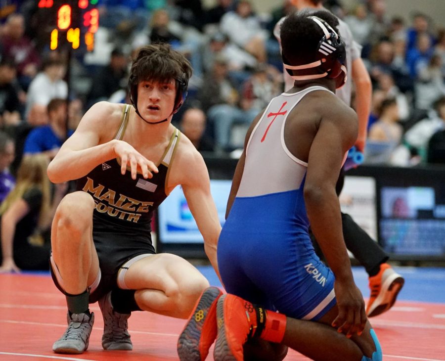 Team captain Josh Berlin wrestles his 138 opponent from Kapaun High. Berlin had been wrestling since middle school and hopes to continue through senior year. 