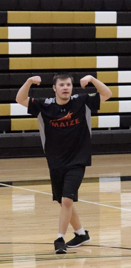Sophomore Jacob Rempel celebrates his basket by flexing his muscle towards the crowd.

